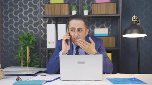 Frustrated Businessman on Phone Call in Office