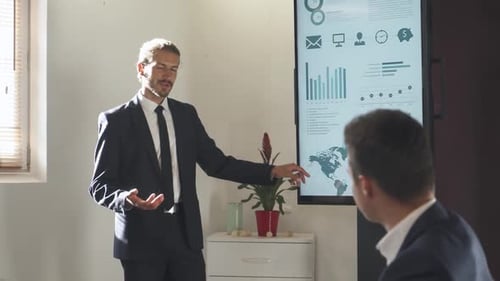 Business Meeting in Office Young Businessman Speak at a Meeting and Shows Financial Infographic in