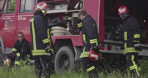Firefighters Standing in Front of Fire Truck