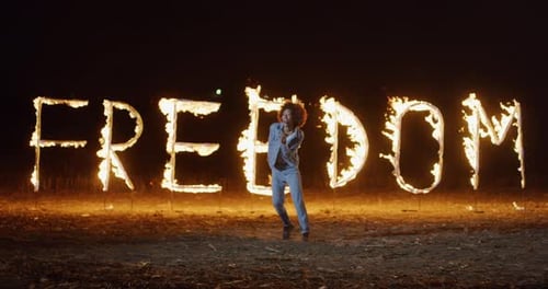 Couple Dancing in Front of Fiery Freedom Sign