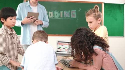 Enthusiastic Children Coding with Teacher in Classroom