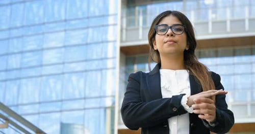 Confident Woman Smiles with Arms Crossed
