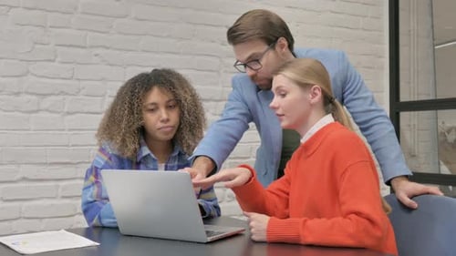 Multiethnic Entrepreneurs Using Laptop in Office