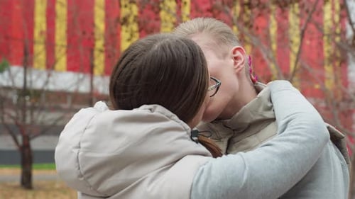 Affectionate Couple Embracing and Kissing Outdoors