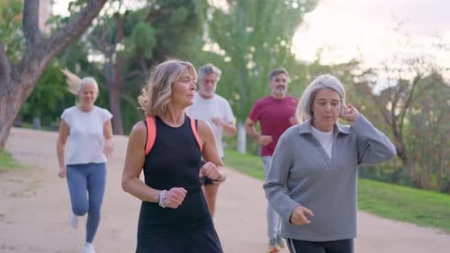 Active Senior People Jogging Together in a Park
