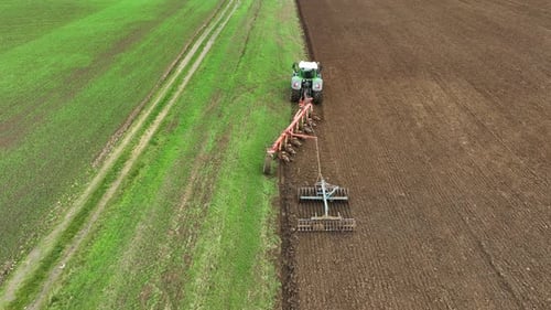 Aerial view of tractor ploughing in Brandenburg, Germany.