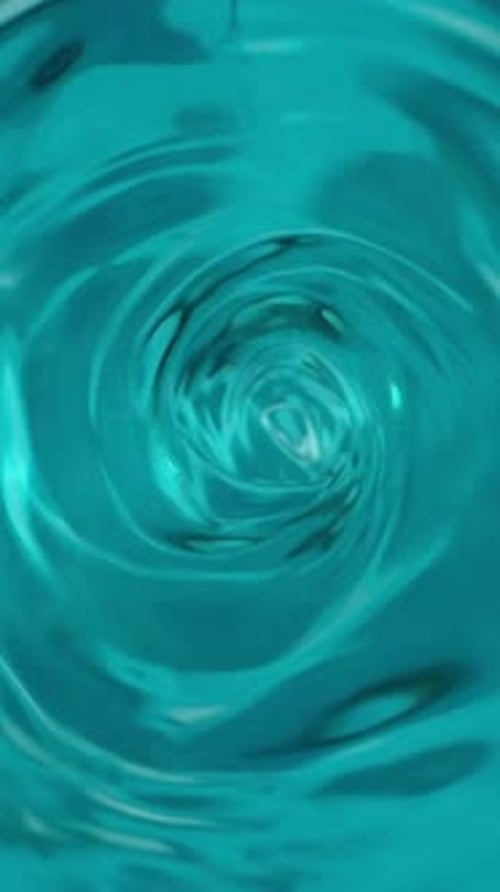 Whirlpool or funnel in water. macro shooting, slow motion. turquoise sea color water Vertical video.