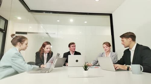 Office Workers Analyzing Statistics Papers in Startup Office