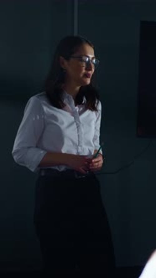 Woman Giving Presentation in Modern Office Setting