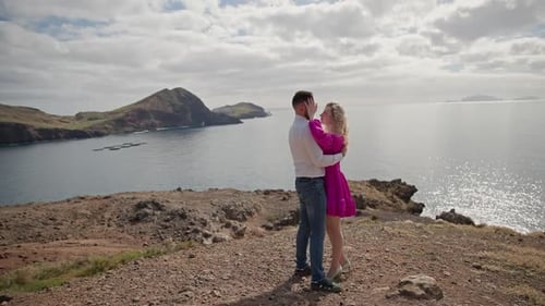 Romantic Couple Embracing on Cliff Overlooking Ocean in Azores