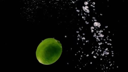 Lime Falling Into Water Creates Bubbles