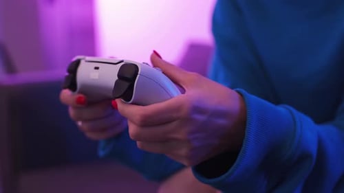 Close Up Shot of Young Woman Playing Game Online at Home in Neon Light