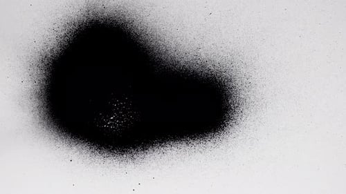 Abstract Black Paint Spreads Across White Surface