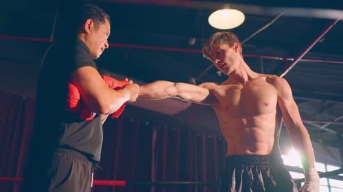 Shirtless Man Getting Boxing Gloves Wrapped