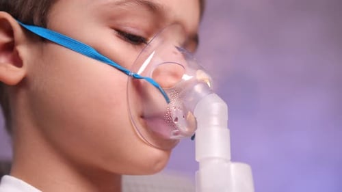 Young Child Using Nebulizer and Oxygen Mask