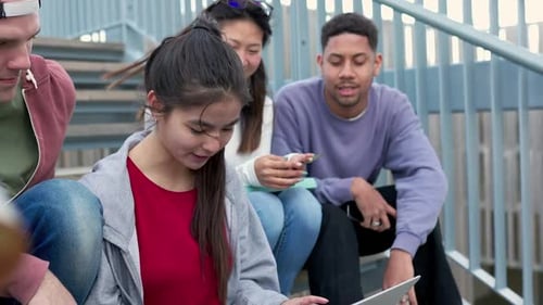Diverse University Students Doing Homework or Grupal Project Together on Laptop