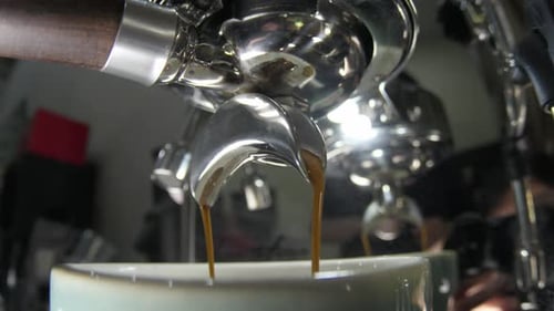 Slow Motion Close-Up of Espresso Extracting Into Cup From Cafe Espresso