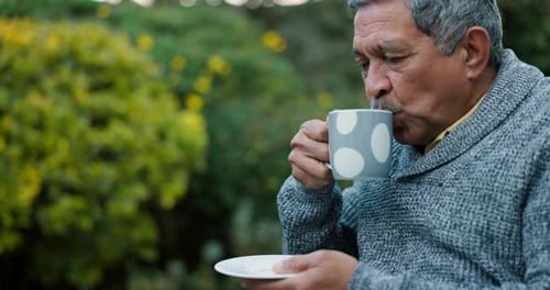 Man Drinking Tea Outside in a Garden
