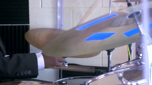 Male musician playing the drum.