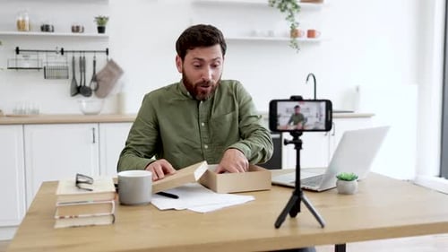 Man Unboxes New Smartphone for Video Blog