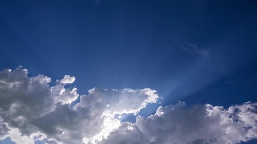 Time lapse of clouds moving as sun rays shine through