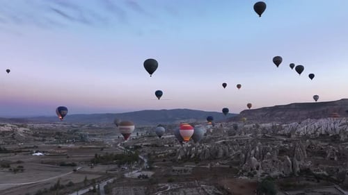Hot Air Balloons Over Rocky Landscape at Sunrise