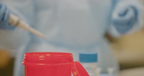 Laboratory Technician Works with Pipette and Sample Container