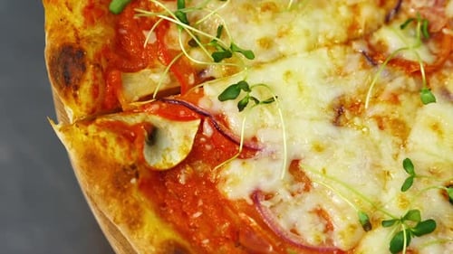 Appetizing pizza. Delicious pastry with bacon, onions, tomatoes and melted cheese.