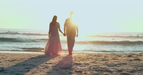 Sunset, man and woman on beach holding hands and walking on sand in summer for date