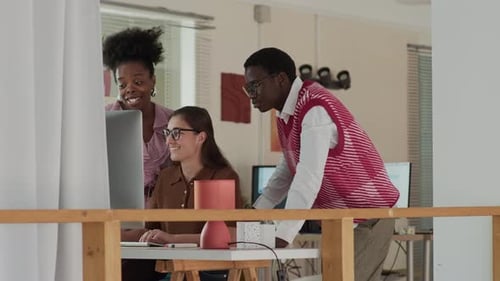 Collaborative Creative Team Effort at Office Computer Station