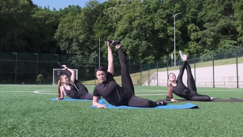 Women Exercising on Yoga Mats in the Park