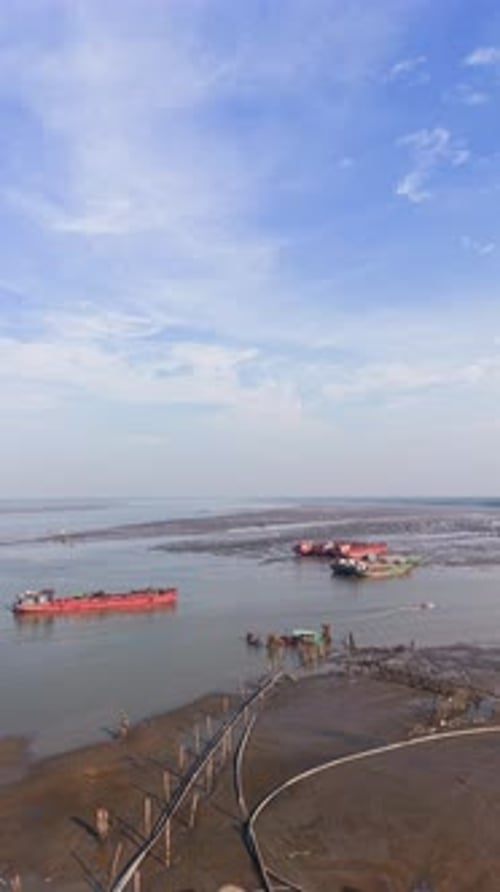 Aerial (Vertical ) View of the Ships and a Boat Near the Coast During Low Tide in Vietnam.