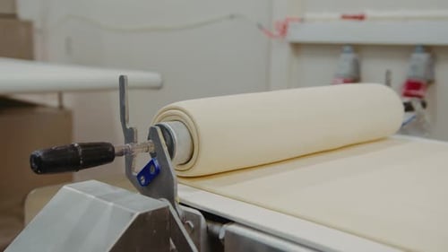 Dough Moving on Conveyor Belt in Factory