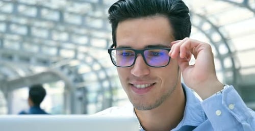 Young Man Using Laptop in Urban Environment