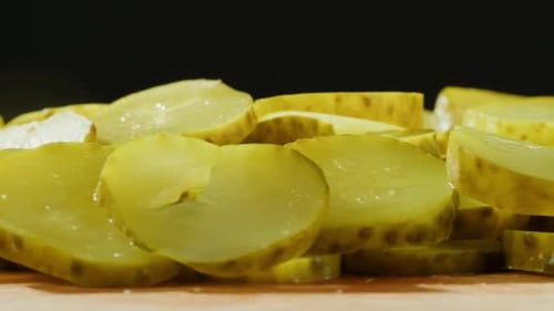 Delicious Sliced Pickles Close-Up on Wooden Surface