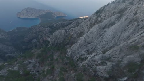 Drone is Flying Down the Mountain on the Shore of Mediterranean Sea in Turkey