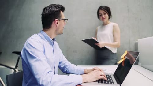 Young business people collaborate on project in modern office environment