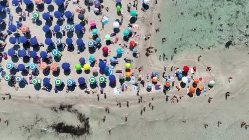 Aerial view on beach, people and umbrellas. Vacation and adventure. Europe, Mediterranean Sea.