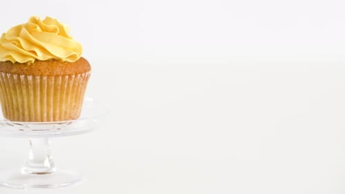 Cupcake with Yellow Frosting on Cake Stand