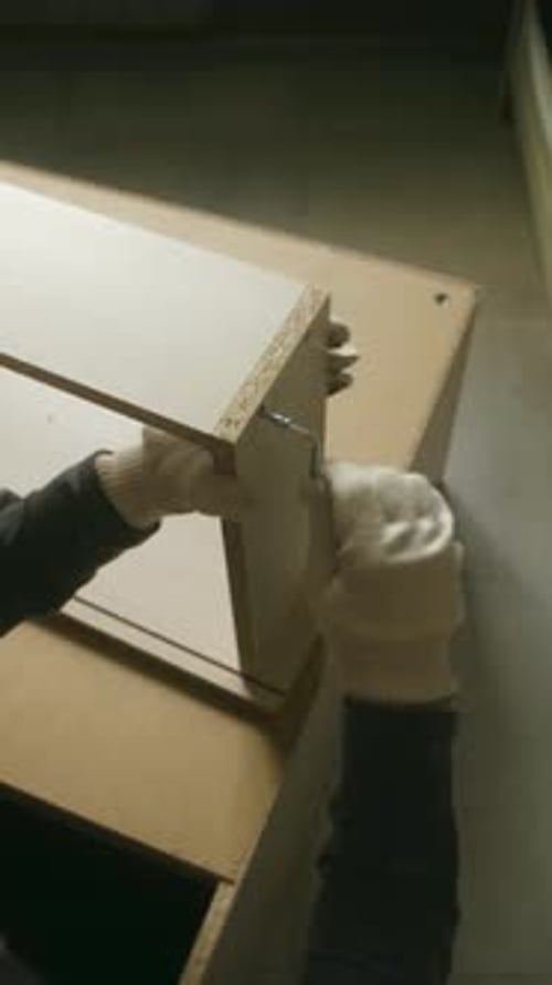 Carpenter Assembling Furniture Using Allen Key