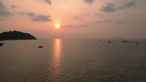 Sunset calm evening, sea with longtail boats on beach. Wonderful aerial view flight drone