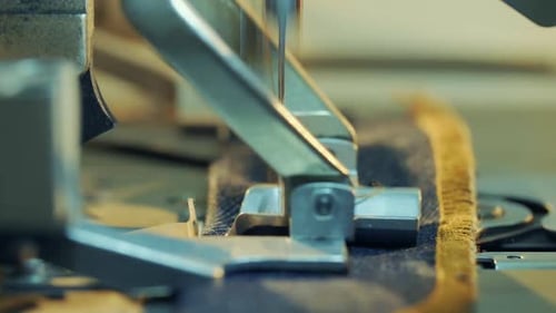 Close-up shot of sewing machine opening buttonhole for jeans.2.