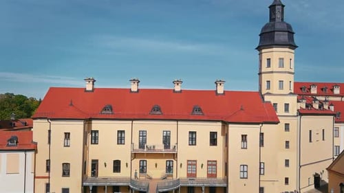 Aerial view on the Nesvizh castle and lake in summer. Moving over beautiful residential castle. Cine