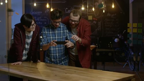 Great Concept For Augmented Reality Mock-up. Three Young Developers Look at Augmented Reality Throu