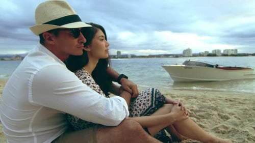 Young Millennial Couple, Spooning on the Beach, Laying in the Sand, Looking