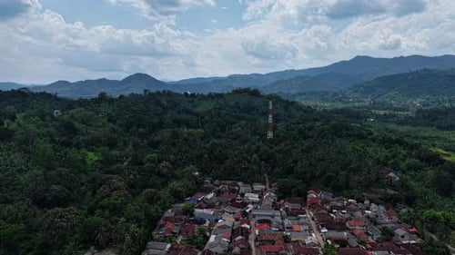 Aerial View Of A Coastal Town Surrounded By Lush Green Mountains (1)