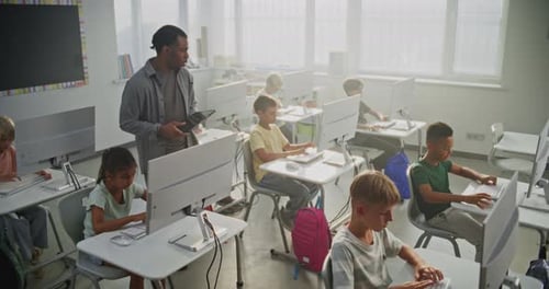 Children Learning Computer Skills in Elementary School Classroom