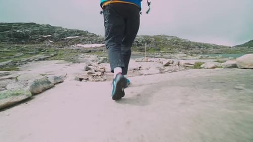 guy travels on a beautiful mountain road in norway