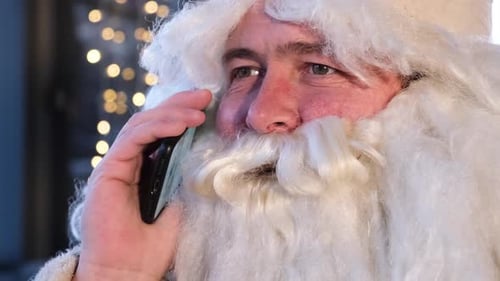 Funny Man in Costume of Santa Claus Talking on Cellphone Face Close Up