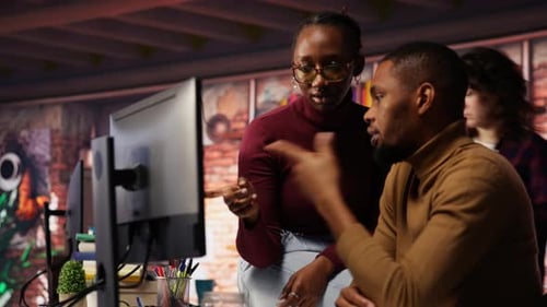 IT Worker and Colleague Programming in AI Startup Office to Build Applications